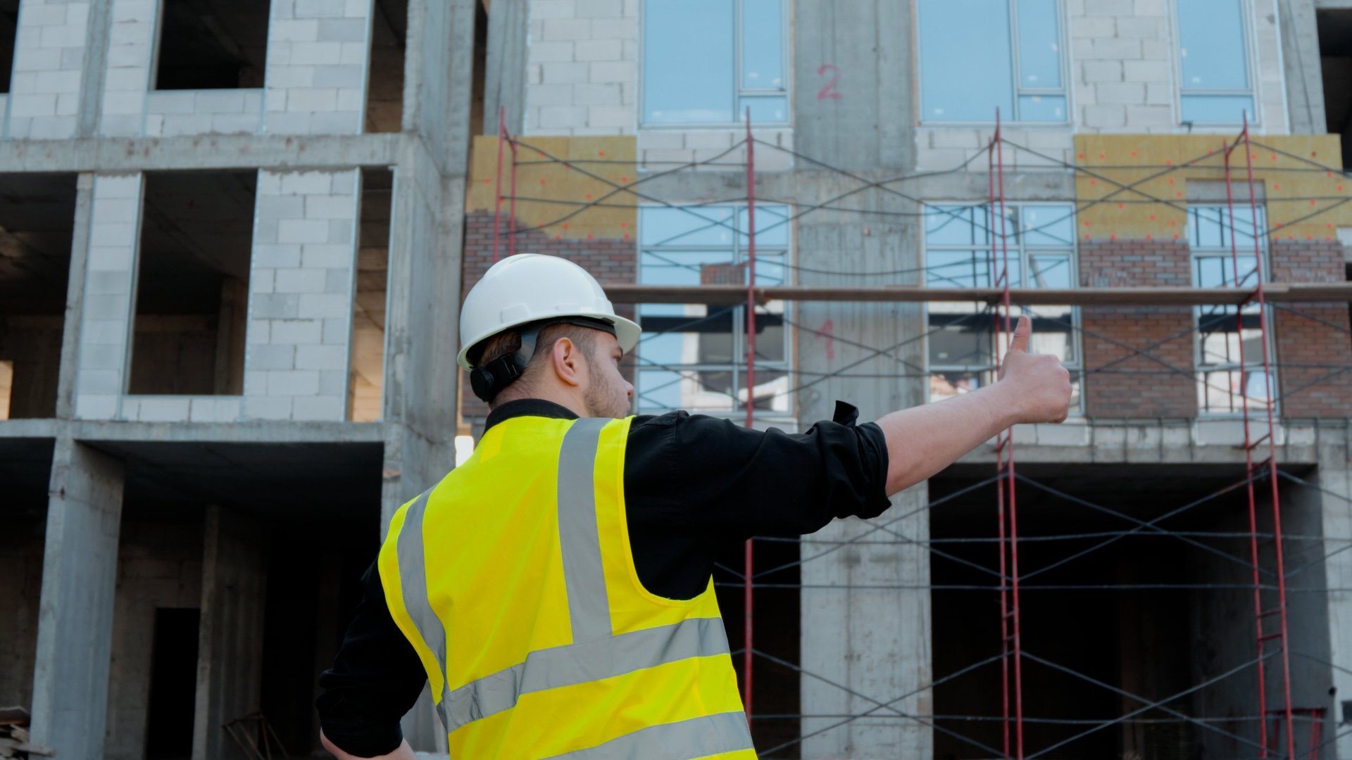 A construction foreman conducts an inspection at a construction site.